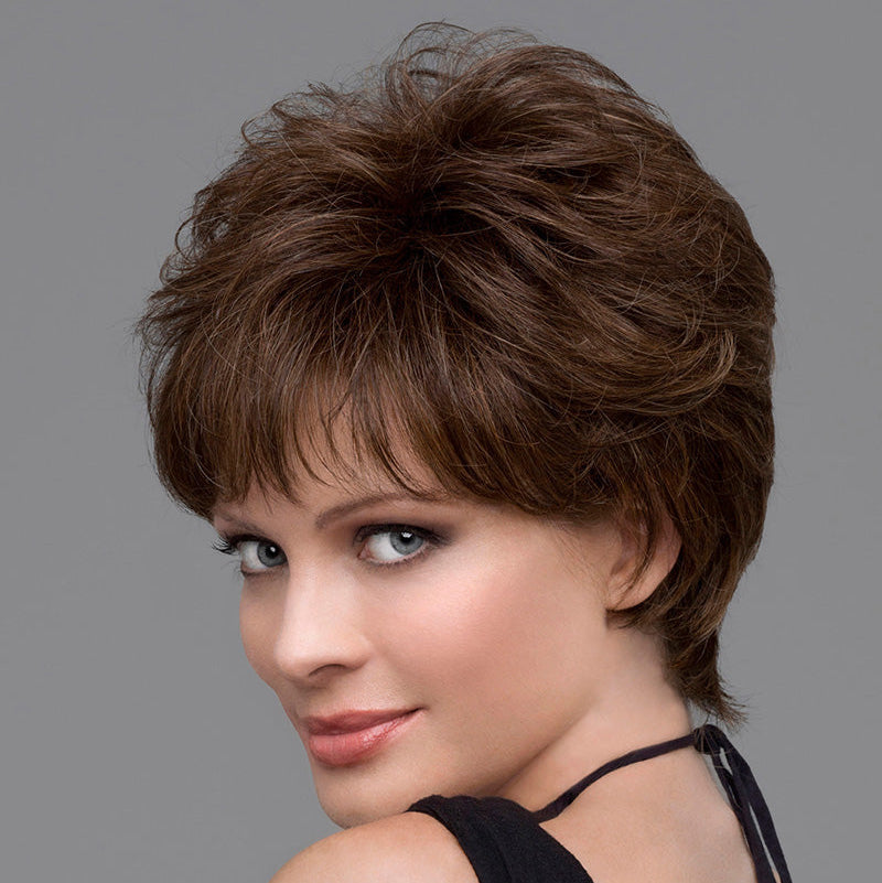 headshot of model wearing brown pixie style wig