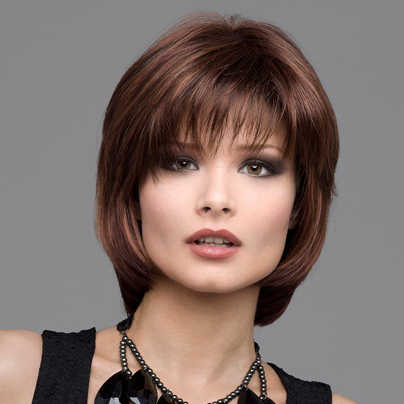 headshot of model wearing brown chin length wig