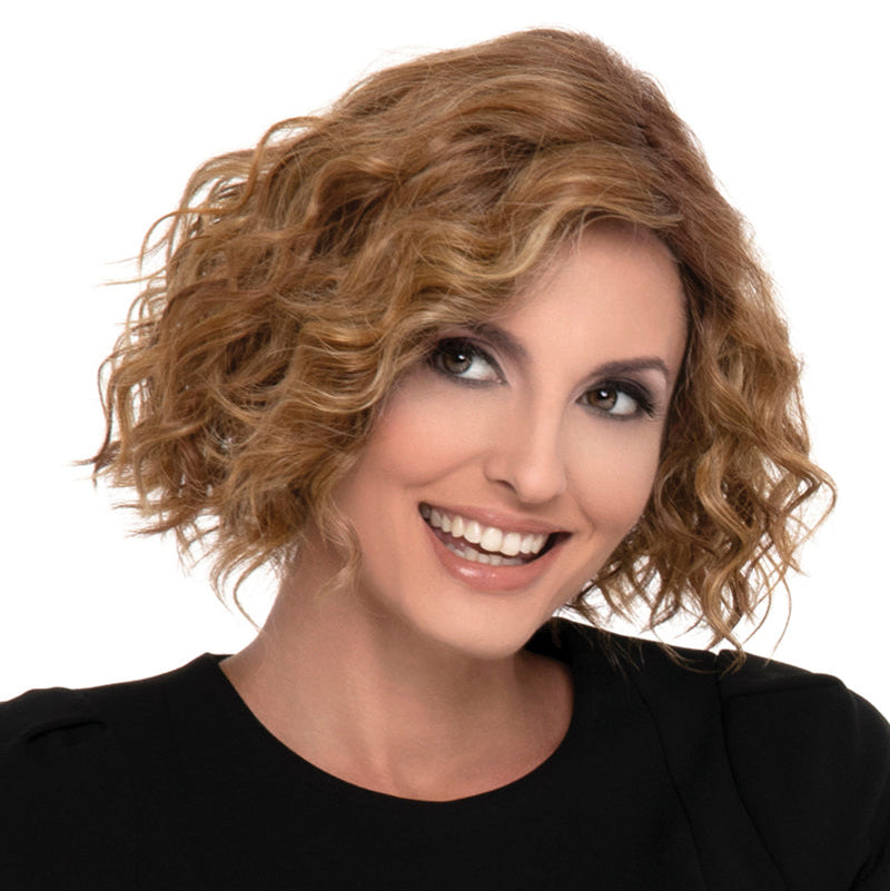 headshot of model wearing curly red wig