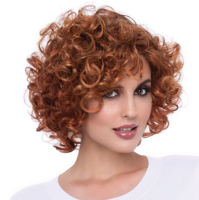 headshot of model wearing short red wig with curls