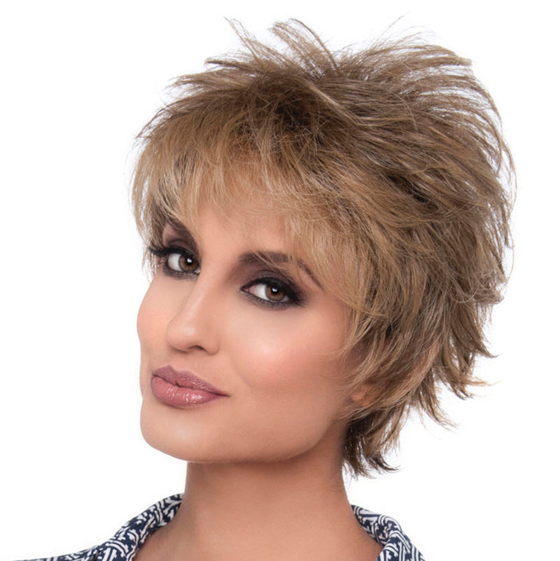 headshot of model wearing light brown spiky style wig