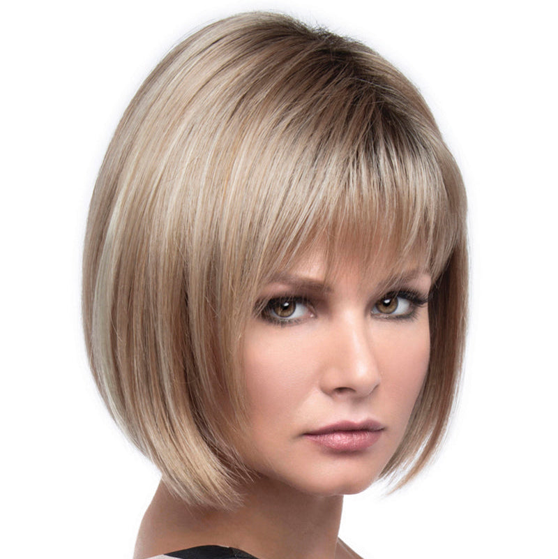 headshot of model wearing blonde chin length wig with bangs