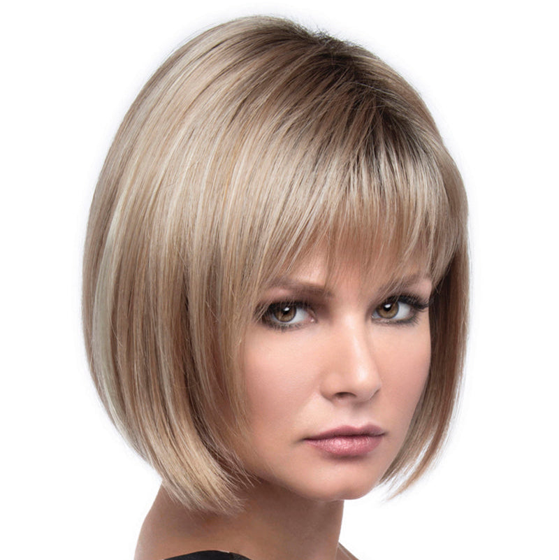 headshot of model wearing blonde chin length wig with bangs